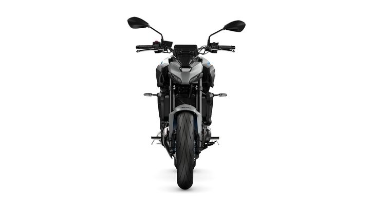 Front view of a modern motorcycle featuring sleek design elements, dual mirrors, and a prominent tire, set against a white background.