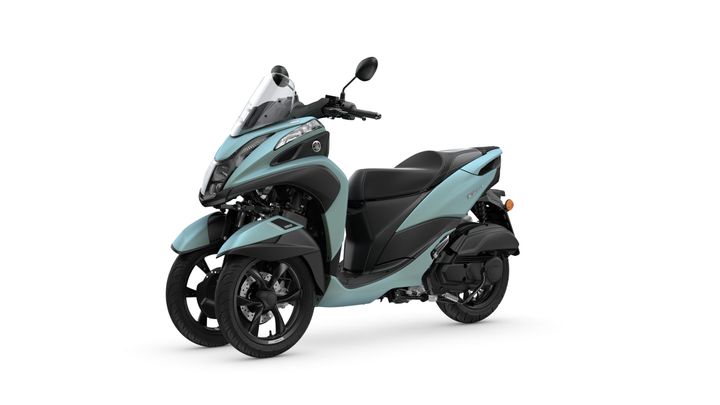 A sleek, turquoise three-wheeled scooter with a modern design, featuring a tall windshield, comfortable seat, and sporty front profile, positioned on a white background.