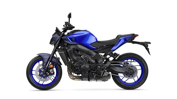 A blue and black sport motorcycle is shown from the side, featuring a sleek design, front and rear disc brakes, and unique blue rims.