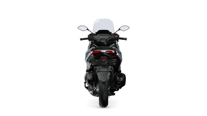 A rear view of a modern motorcycle with a sleek design, featuring a low-profile windshield, dual rear lights, and an exposed exhaust, set against a plain white background.