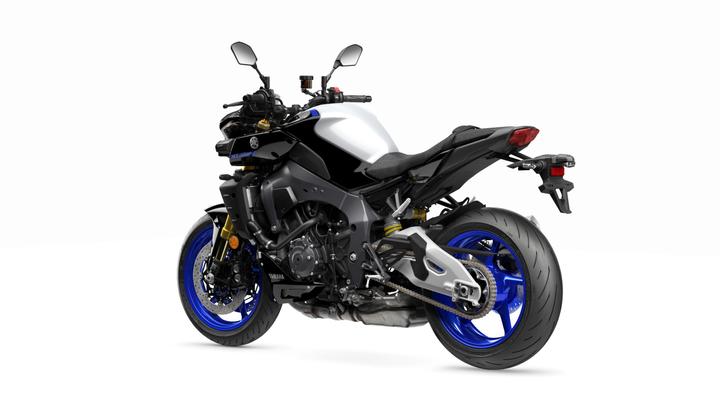 A sleek, modern motorcycle in a black and white color scheme with blue accents, viewed from the rear, showcasing its sporty design and distinctive features.