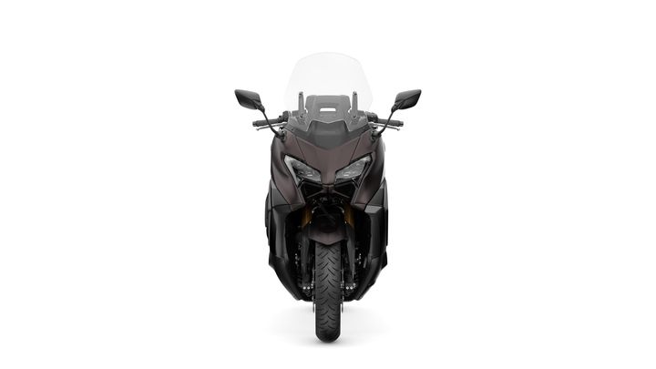 Front view of a sleek motorcycle with a dark finish, featuring a prominent windshield and distinctive headlights, positioned against a white background.