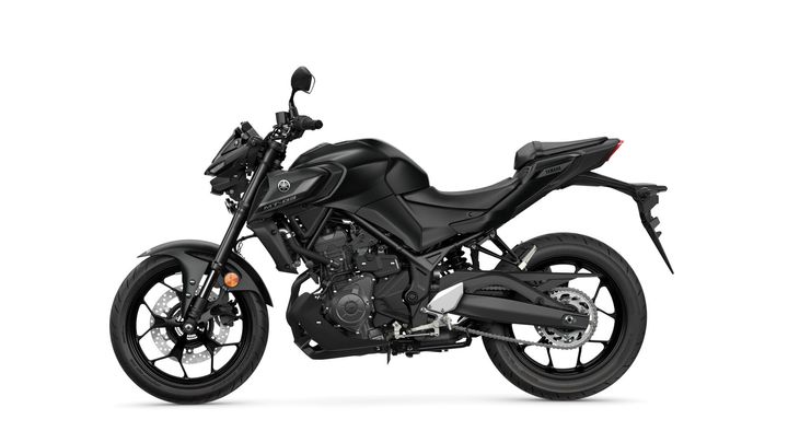 A sleek black Yamaha MT-03 motorcycle is viewed from the side, showcasing its modern design, compact frame, and sporty profile.