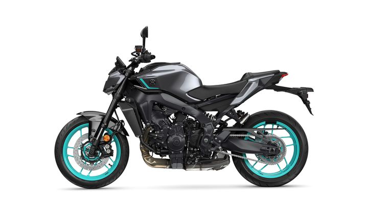 A sleek, modern motorcycle with a dark gray body and turquoise accents, featuring a sporty design, sharp lines, and distinctive wheels.