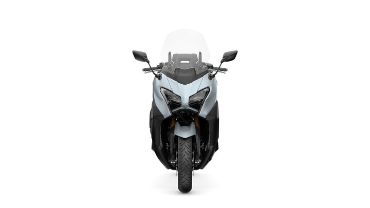 Front view of a modern motorcycle featuring a sleek design, prominent headlights, and a tall windshield, against a white background.