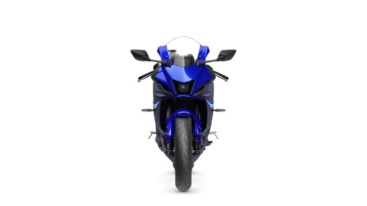 Front view of a blue Yamaha motorcycle showcasing its sleek design, including the headlight and handlebars, against a white background.