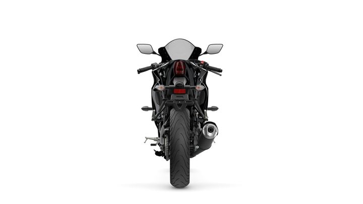 A sleek black sports motorcycle viewed from the rear, showcasing its distinctive tail light, dual exhaust, and sleek, aerodynamic design.
