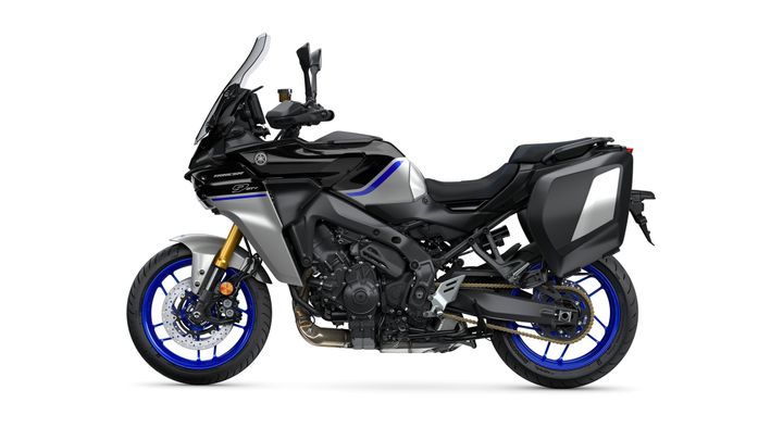 A sleek black and silver sport touring motorcycle with blue accents, featuring saddlebags, a tall windshield, and advanced styling, positioned on a white background.