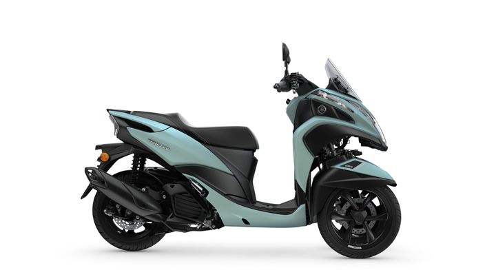 A side view of a turquoise and black Yamaha Tricity scooter showcasing its sleek design, seated on a white background.