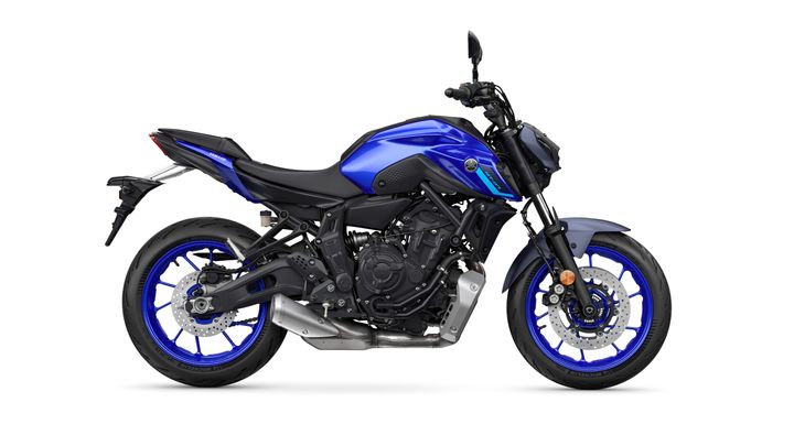 Side view of a blue Yamaha MT-07 motorcycle, featuring a sleek design with a prominent headlight, sporty frame, and distinctive blue rims.