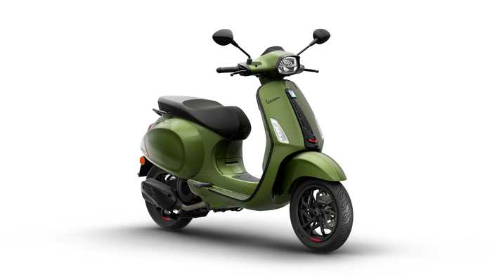 A green Vespa scooter featuring a sleek design, black seat with red stitching, and modern styling elements, set against a white background.