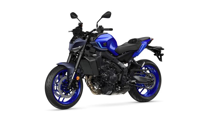 A sleek blue and black motorcycle positioned at a slight angle, showcasing its sporty design, prominent front suspension, and distinctive wheels.