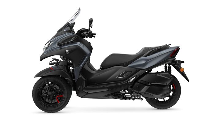 A sleek black and gray scooter with a modern design, featuring a tall windscreen and dual front headlights, positioned against a white background.