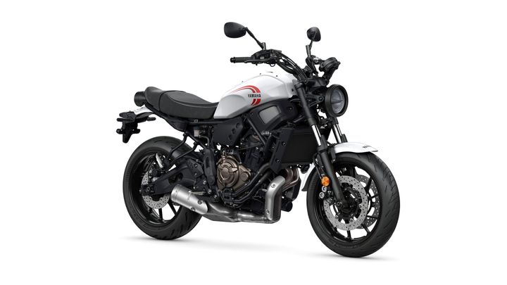 Yamaha 2024 XSR 700 A modern motorcycle with a white and black color scheme, featuring a prominent Yamaha logo, low-profile seat, and sleek design elements, positioned at an angle to showcase its features.