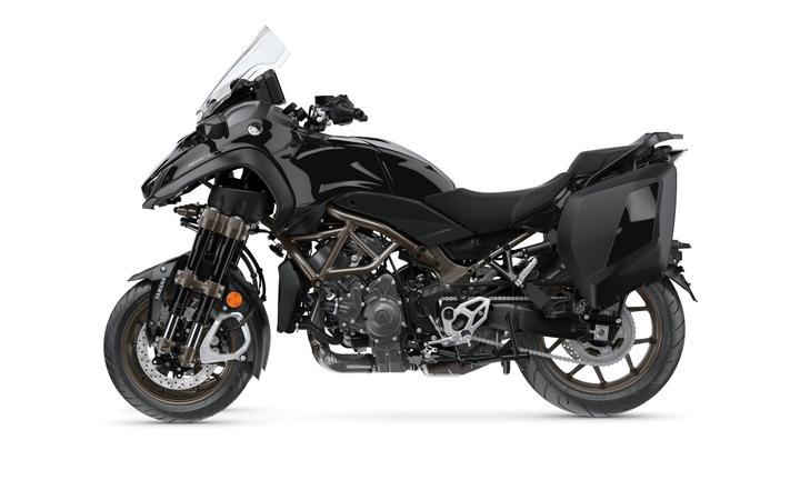 A sleek black motorcycle with a modern design, featuring a prominent windshield, aerodynamic bodywork, and a sturdy frame with visible engine components. The bike has an aggressive stance and includes side panniers for storage.