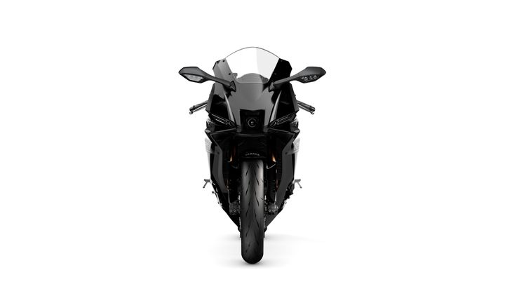 A sleek black motorcycle viewed from the front, showcasing its aerodynamic design and sharp headlights against a white background.