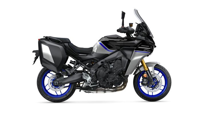 A sleek black and silver motorcycle with blue accents and sporty design, featuring saddlebags and a tall windshield.