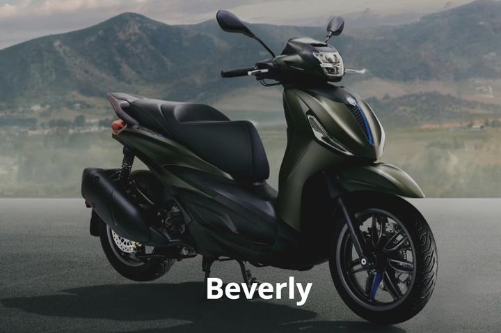 A sleek, modern scooter in a deep green color, featuring a streamlined design and stylish black accents, set against a backdrop of rolling mountains. The word "Beverly" is prominently displayed in white at the bottom of the image.