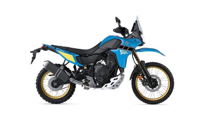 A blue and black adventure motorcycle with yellow accents, featuring a distinct design, off-road tires, and a robust frame.