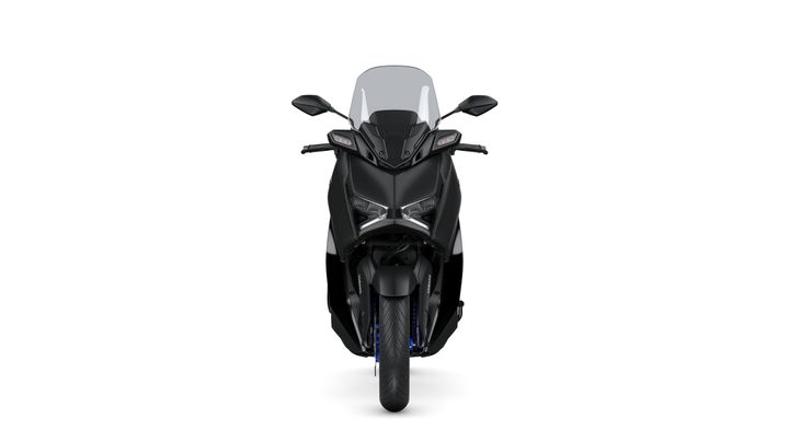 A sleek, black motorcycle facing forward, featuring a large windshield, angular headlights, and a robust front tire.