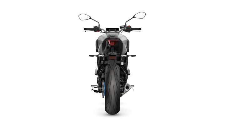 A sleek motorcycle viewed from the rear, showcasing its modern design, large rear tire, and distinctive tail light against a white background.