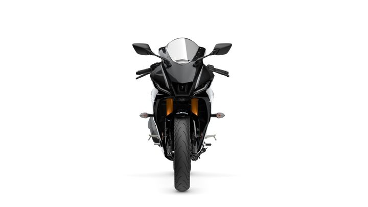 A front view of a sleek, modern motorcycle with a black and white color scheme, featuring sharp lines, a clear windshield, and illuminated accents. The motorcycle's front tire is prominently displayed, alongside stylish side mirrors and a bold brand logo.