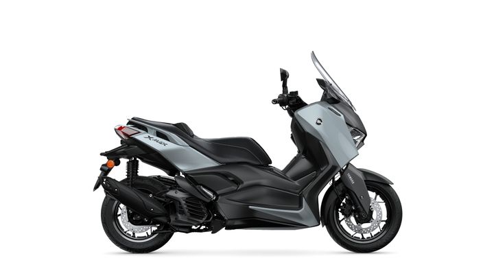A sleek gray scooter with a modern design, featuring a windscreen, comfortable seat, and distinct body lines, set against a white background.