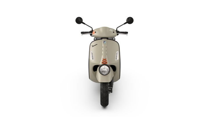 A front view of a beige Vespa scooter with a round headlight and minimalistic design features, set against a white background.