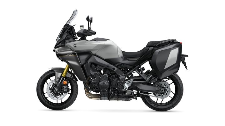 A sleek, gray touring motorcycle with a large windshield, side panniers, and a sporty design, shown from the left side on a white background.