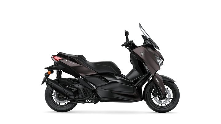 A sleek black Yamaha XMAX scooter displayed from the side, featuring a modern design, prominent windscreen, and sporty lines.