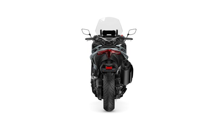 A sleek motorcycle viewed from the rear, showcasing its black body, prominent tail light, and exhaust. The handlebars and mirrors are visible at the top, complemented by a windshield. The motorcycle features a rugged tire, indicating off-road capability.