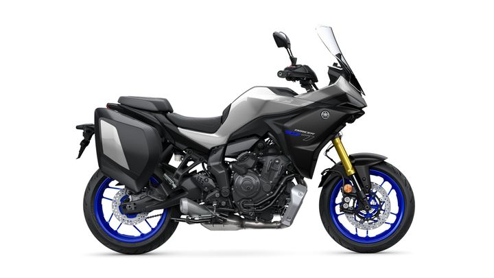 A sleek, modern Yamaha motorcycle in gray and black, featuring blue wheels and side panniers, viewed from the side against a white background.
