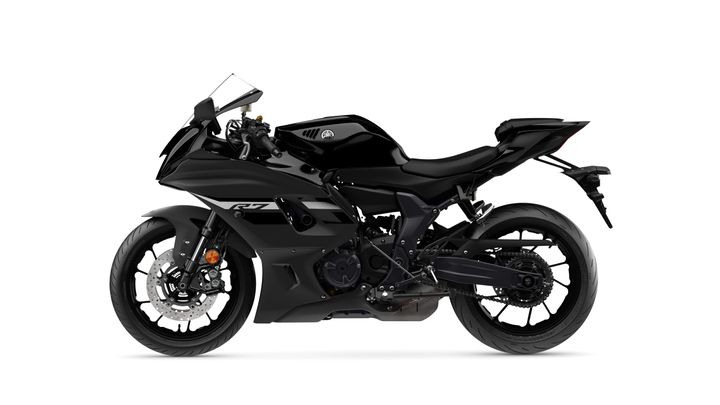A sleek, black Yamaha R7 motorcycle shown from the side, highlighting its aerodynamic design, sporty stance, and intricate details on the body and wheels.