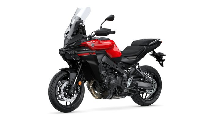 A sleek, red and black sport touring motorcycle with a large windscreen and modern design, displaying a powerful engine and robust tires.