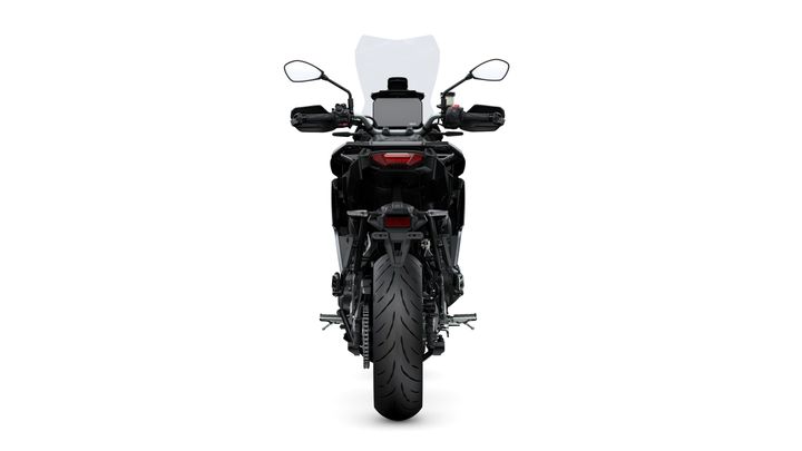 A black motorcycle viewed from the rear, featuring a prominent rear tire, mirrors, handlebars, and a transparent windscreen.
