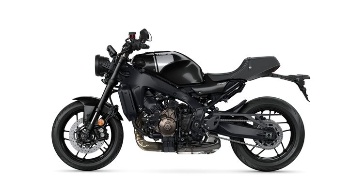 A sleek black Yamaha XSR900 motorcycle shown from the side, featuring a minimalist design with a round headlight, sporty bodywork, and distinct engine detailing.