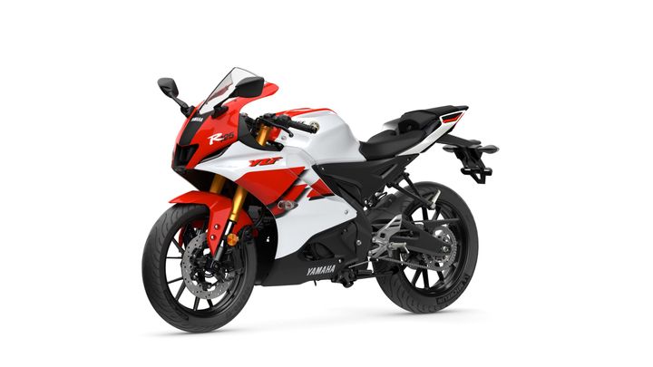 A Yamaha R25 sports motorcycle featuring a striking red and white color scheme, with a sleek aerodynamic design, high-performance components, and modern styling elements.