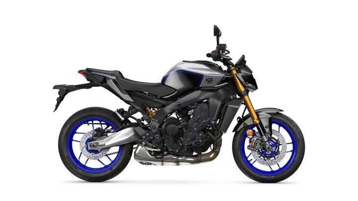 A sleek black and blue Yamaha motorcycle with a notable golden front fork and a modern design, showcased from the side on a white background.