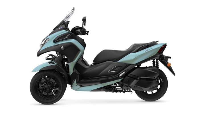 A side view of a light blue and black Yamaha scooter with a sleek design, featuring two wheels and a sporty windscreen.