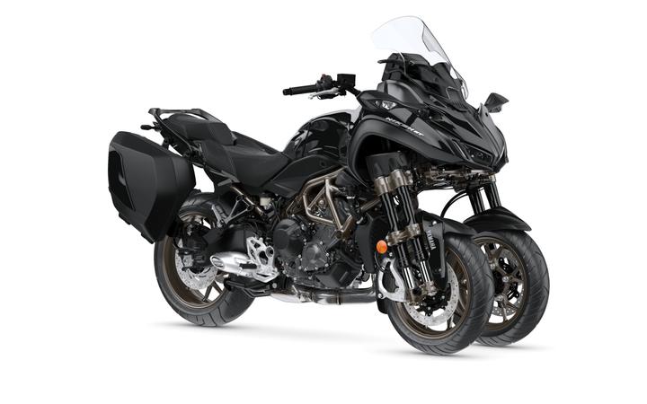 Yamaha 2023 Niken GT A sleek black motorcycle with three wheels, featuring a large windshield, a low-profile seat, and sturdy panniers on the sides. The design emphasizes modern aesthetics and practicality for touring.