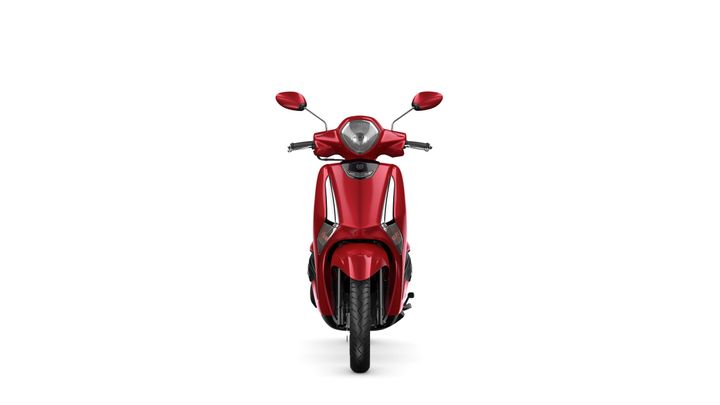 A red scooter viewed head-on, displaying its sleek design, front lights, and handlebars against a white background.