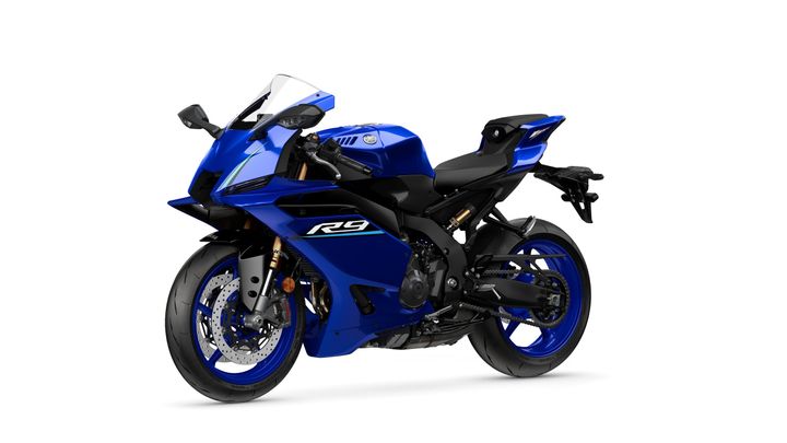 A bright blue Yamaha R9 motorcycle angled to the right, showcasing its sleek design, aerodynamic body, and detailed wheels against a white background.