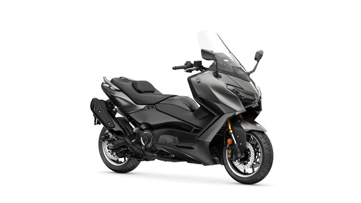 A sleek, modern touring motorcycle in matte black with a tall windshield, prominent fairings, and gold suspension components, angled to showcase its design and features.