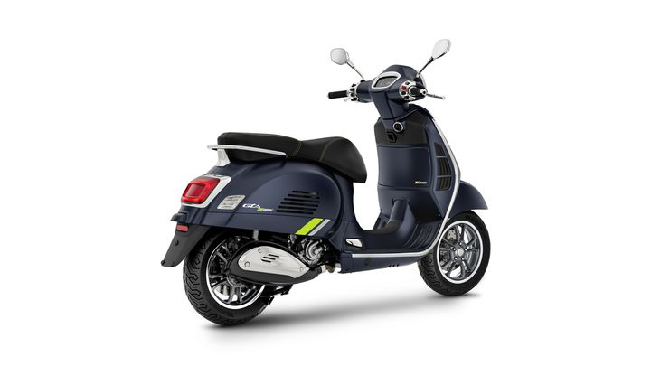 A stylish navy blue scooter with a sleek design, featuring a comfortable seat and modern chrome accents. The scooter is positioned at an angle to showcase its rear and side profile.