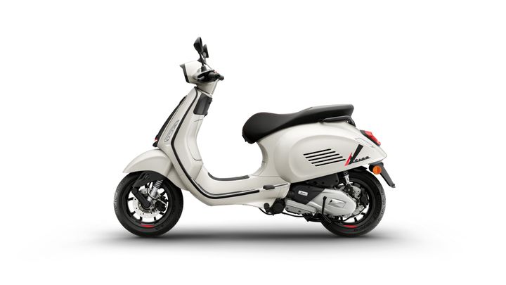 A white scooter with a sleek design, featuring a black seat, visible wheels, and modern details.