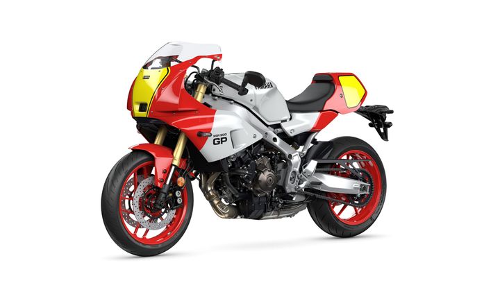 A red and silver Yamaha XSR900 GP motorcycle with sporty fairings and distinctive yellow accents, showcasing a sleek design and modern features.