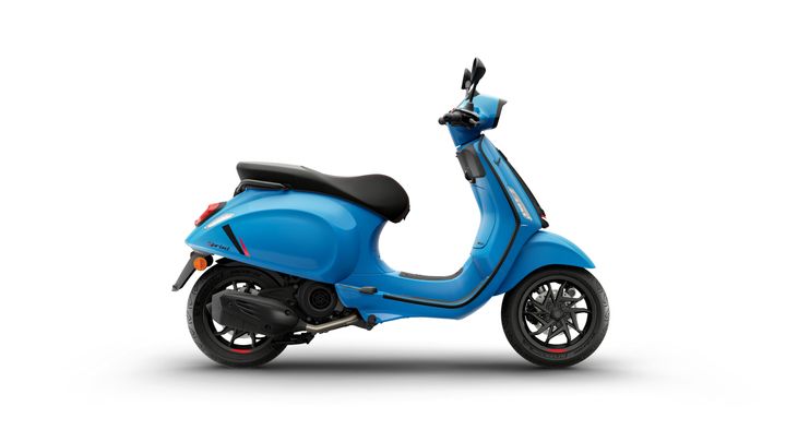 A bright blue scooter is shown from the side, featuring a sleek design, black seat, and distinctive wheels.