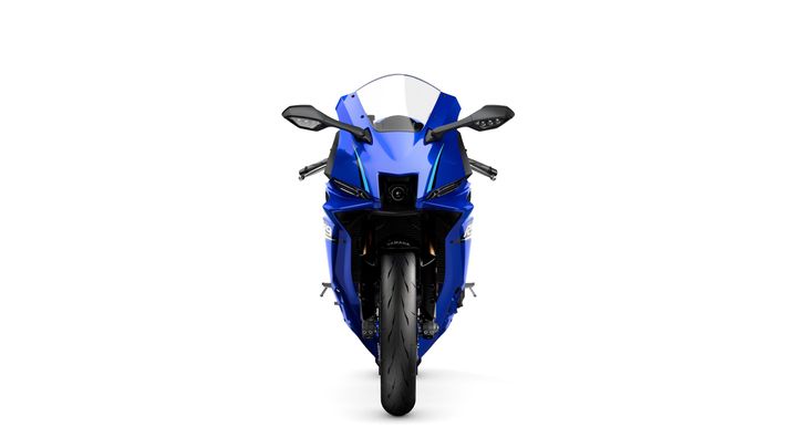 A front view of a blue sport motorcycle with a sleek design, featuring prominent headlights, handlebars, and a large tire.