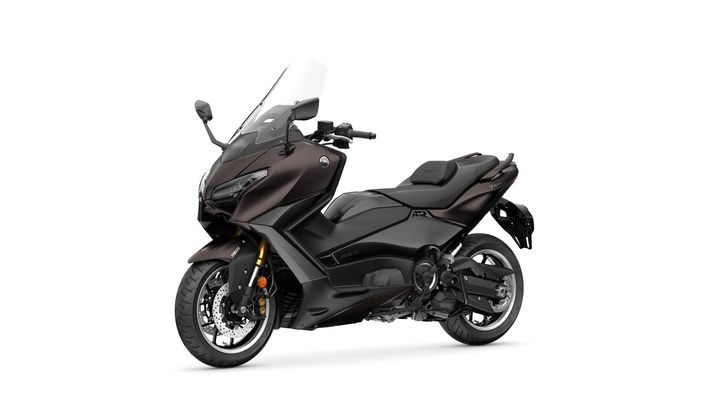 A sleek, modern scooter with a dark metallic finish, featuring a large windshield, a comfortable seat, and distinctive Yamaha branding on the side.