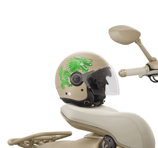 A motorcycle helmet with a green dragon decal on the side placed on a beige scooter seat.